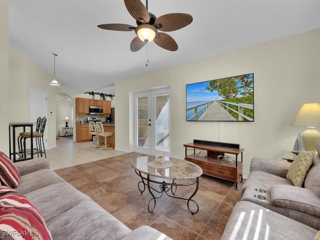 living room with french doors, ceiling fan, vaulted ceiling, and light tile patterned floors