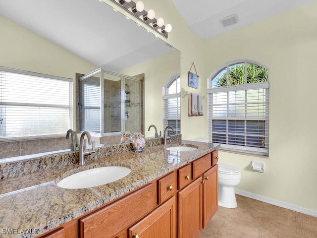 bathroom featuring lofted ceiling, vanity, walk in shower, toilet, and tile patterned floors