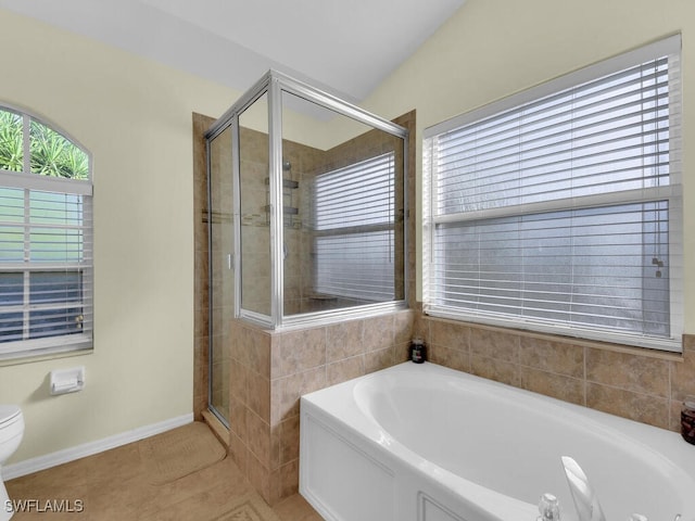 bathroom with tile patterned flooring, toilet, and separate shower and tub