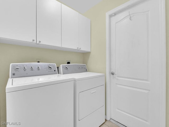 washroom with cabinets and separate washer and dryer