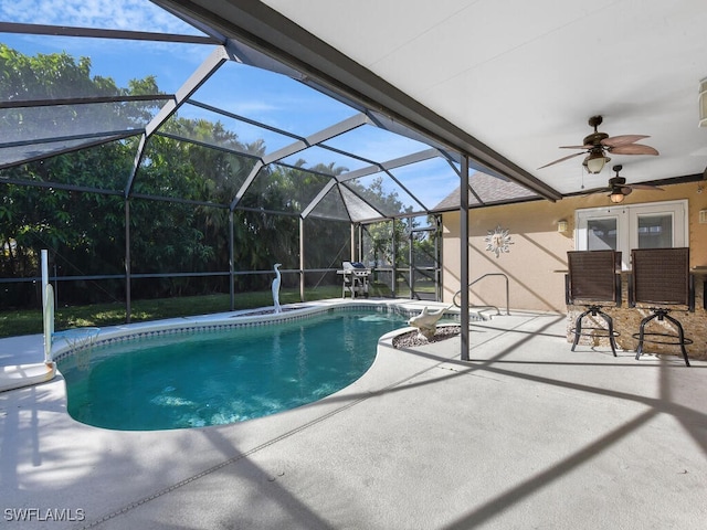 view of pool featuring a patio, ceiling fan, and glass enclosure