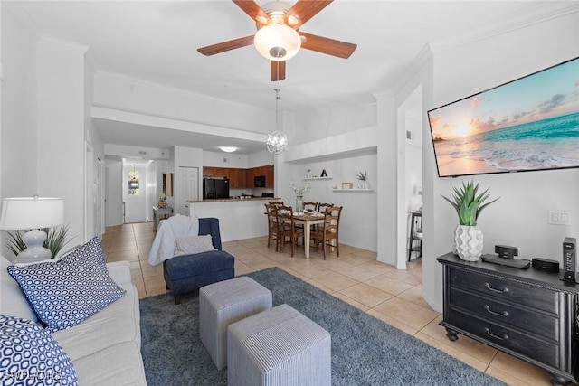 living room featuring light tile patterned floors, ceiling fan with notable chandelier, and ornamental molding