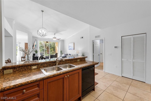 kitchen featuring sink, dishwasher, dark stone countertops, hanging light fixtures, and light tile patterned flooring