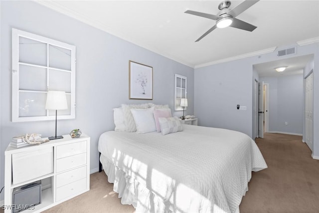 bedroom featuring crown molding, light colored carpet, and ceiling fan