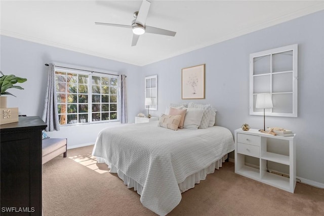 carpeted bedroom featuring crown molding and ceiling fan