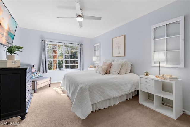 bedroom featuring crown molding, light colored carpet, and ceiling fan