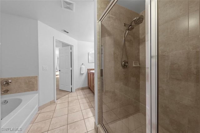 bathroom with vanity, shower with separate bathtub, and tile patterned flooring