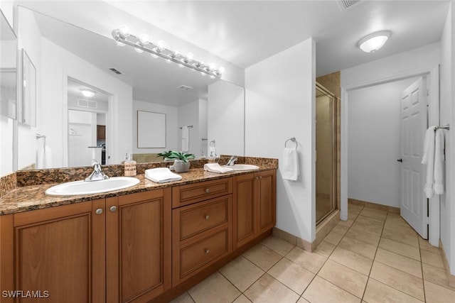 bathroom with vanity, tile patterned flooring, and a shower with door