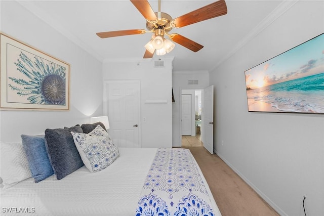 carpeted bedroom with ornamental molding and ceiling fan