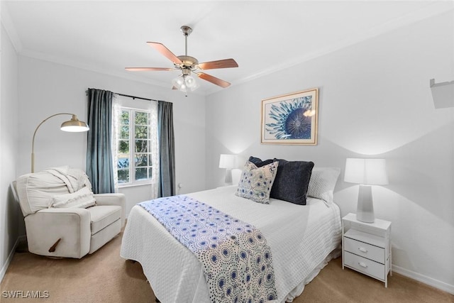 carpeted bedroom with ornamental molding and ceiling fan