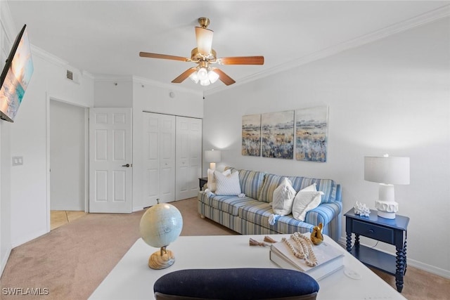 carpeted living room with crown molding and ceiling fan