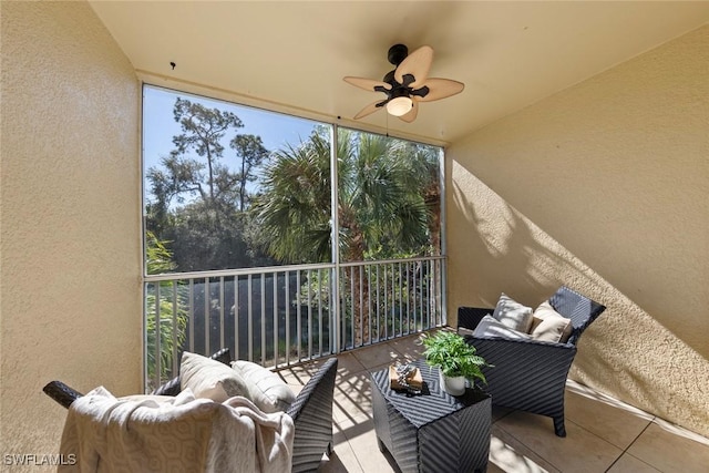 sunroom / solarium featuring ceiling fan and a wealth of natural light