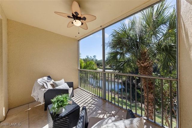 balcony with a water view and ceiling fan