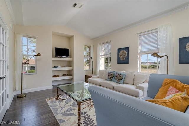 living room with a healthy amount of sunlight, lofted ceiling, dark wood-type flooring, and built in shelves