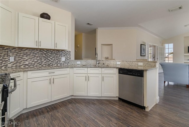 kitchen with tasteful backsplash, appliances with stainless steel finishes, kitchen peninsula, light stone countertops, and white cabinets