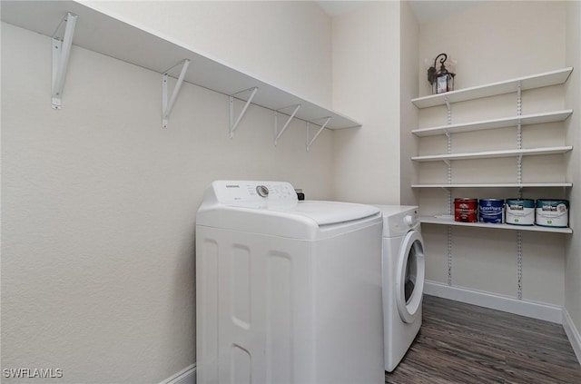 washroom featuring dark hardwood / wood-style floors and washing machine and clothes dryer