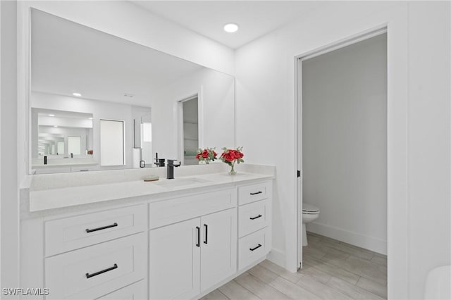 bathroom featuring vanity and toilet