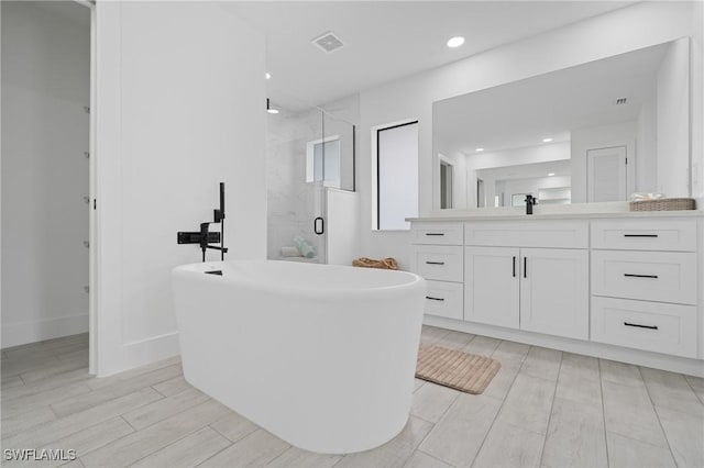 bathroom featuring independent shower and bath and vanity