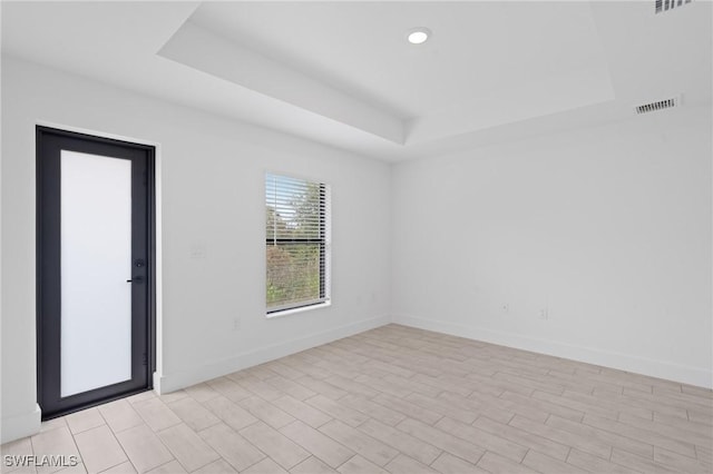 empty room featuring a tray ceiling