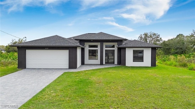 prairie-style house with a garage and a front lawn