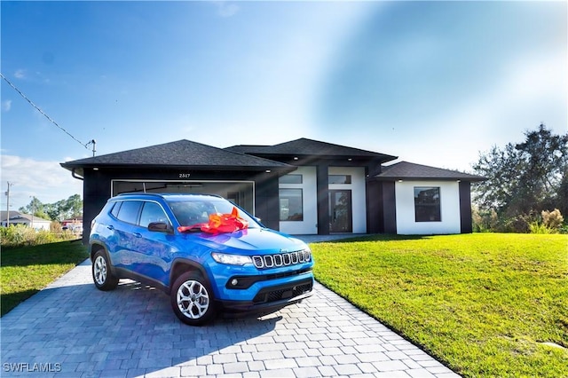 view of front of property with a garage and a front yard