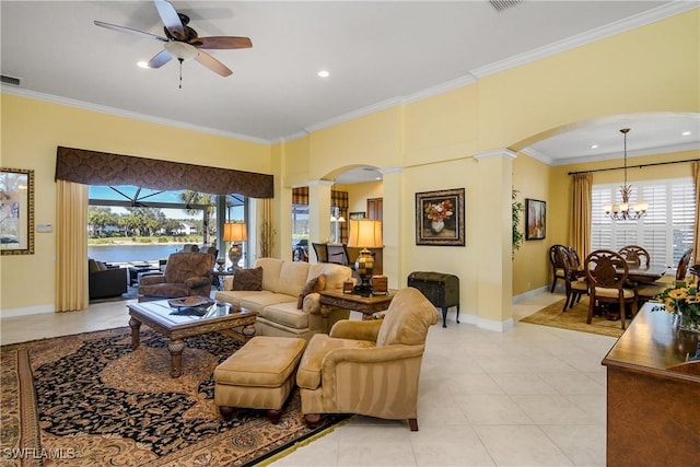 tiled living room with ceiling fan with notable chandelier, ornamental molding, a water view, and a towering ceiling