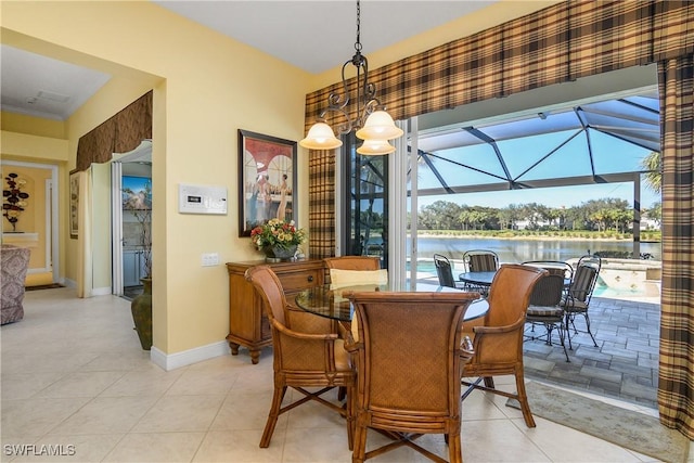 tiled dining area featuring a water view