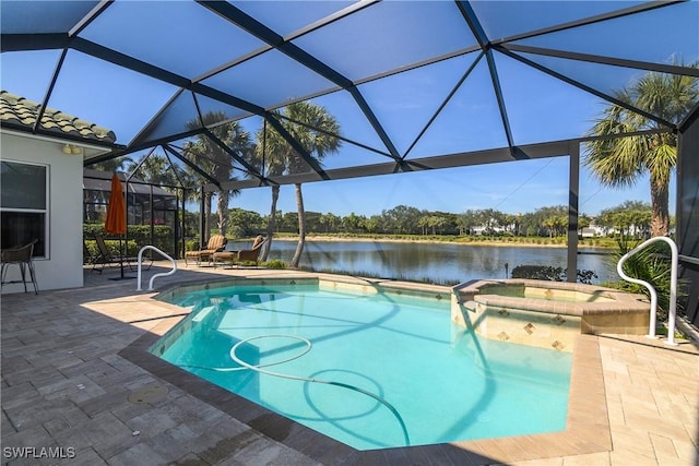 view of pool with a lanai, a patio area, a water view, and an in ground hot tub