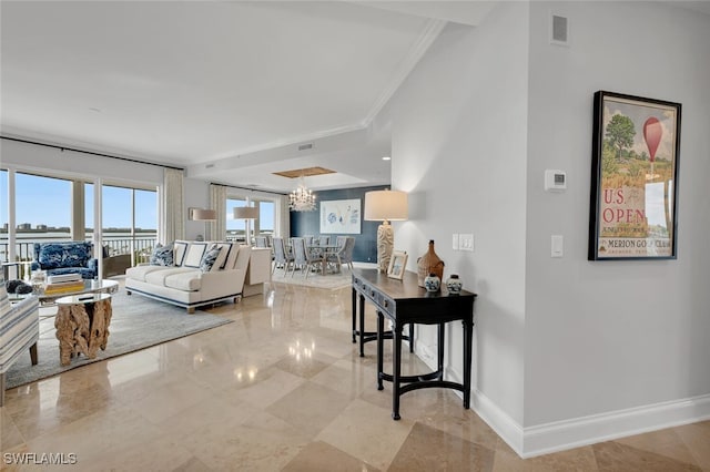 living room featuring crown molding, a notable chandelier, visible vents, and baseboards