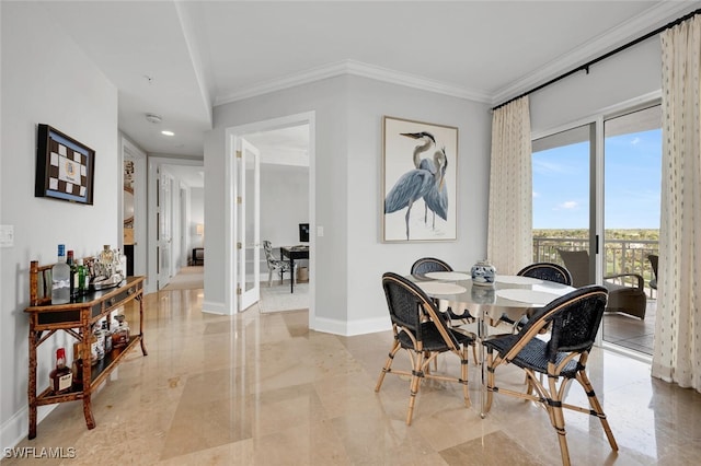 dining room featuring ornamental molding, marble finish floor, and baseboards