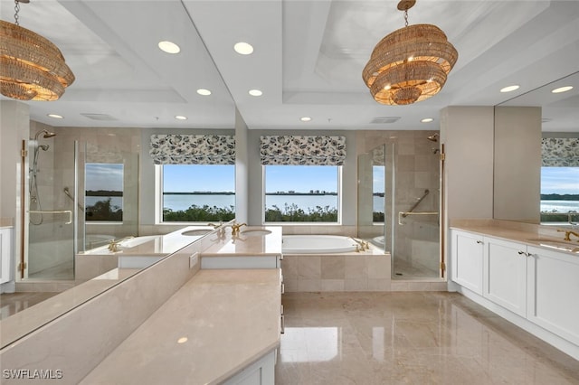 bathroom with a bath, a stall shower, a tray ceiling, and a sink