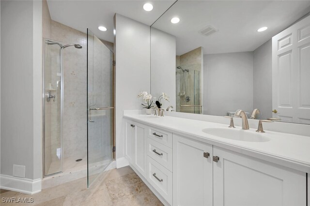 full bathroom featuring double vanity, a sink, visible vents, and a shower stall