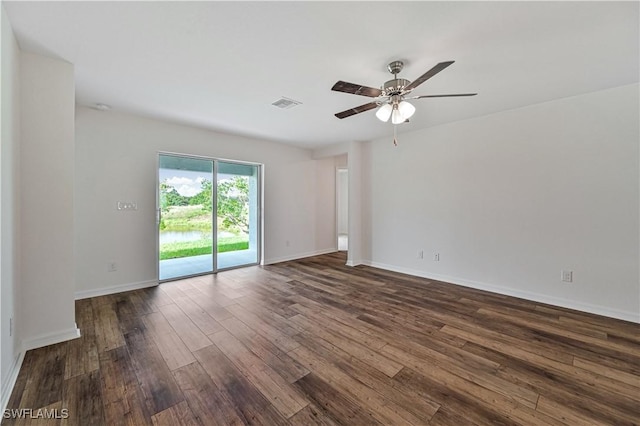 unfurnished room with ceiling fan and dark hardwood / wood-style flooring