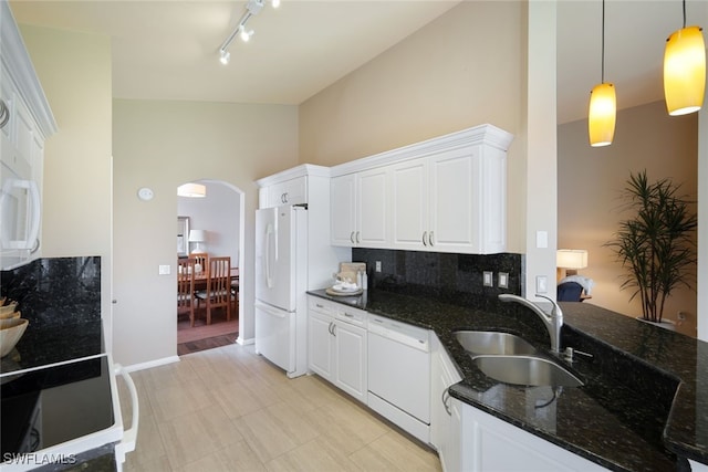 kitchen with sink, white cabinetry, pendant lighting, white appliances, and dark stone counters