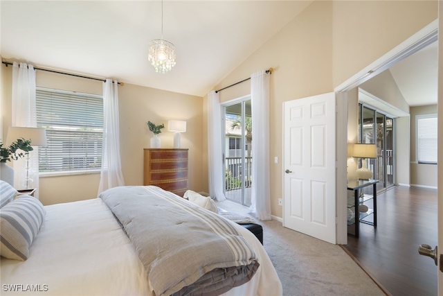 carpeted bedroom featuring vaulted ceiling, access to outside, and a chandelier