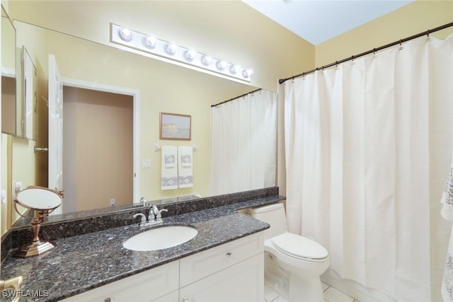 bathroom with vanity, curtained shower, tile patterned floors, and toilet