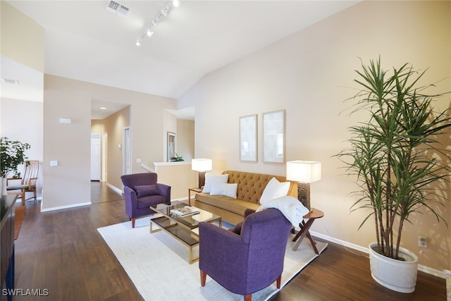 living room featuring lofted ceiling, dark hardwood / wood-style floors, and rail lighting