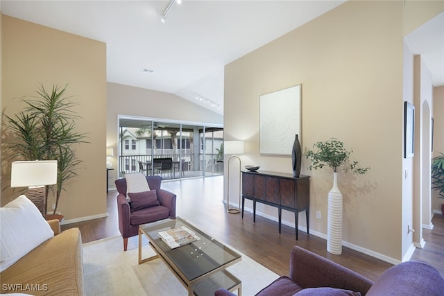 living room featuring lofted ceiling and hardwood / wood-style floors