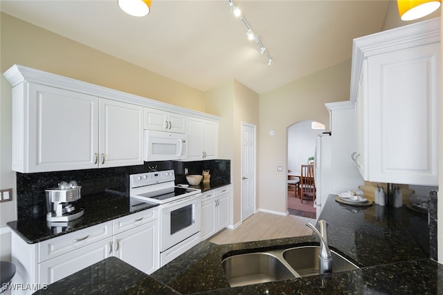 kitchen featuring sink, white appliances, decorative backsplash, and white cabinets