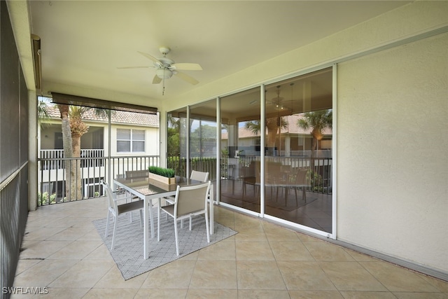 unfurnished sunroom featuring ceiling fan