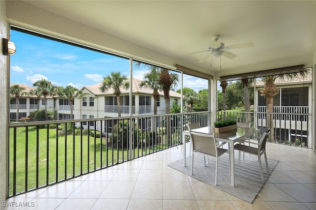 sunroom with a healthy amount of sunlight and ceiling fan