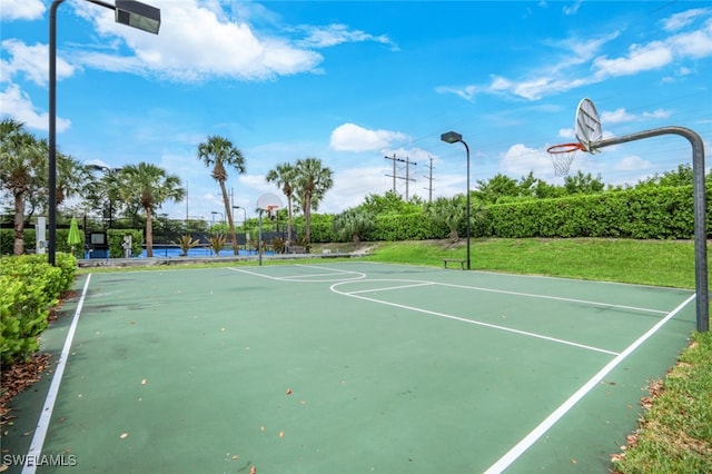 view of sport court with a yard