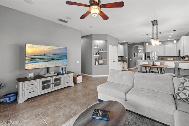 living room featuring tile patterned floors and ceiling fan