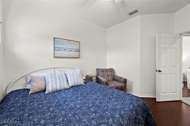 bedroom with dark wood-type flooring and vaulted ceiling