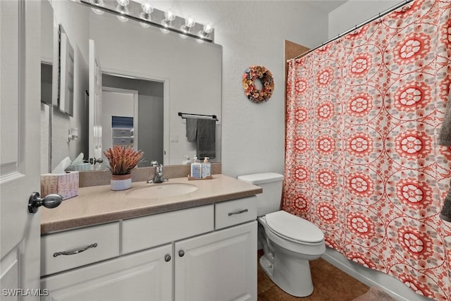 bathroom featuring vanity, tile patterned floors, and toilet