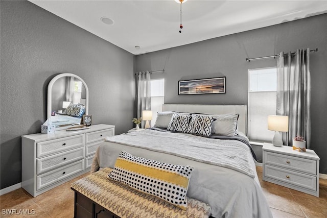 bedroom with light tile patterned floors