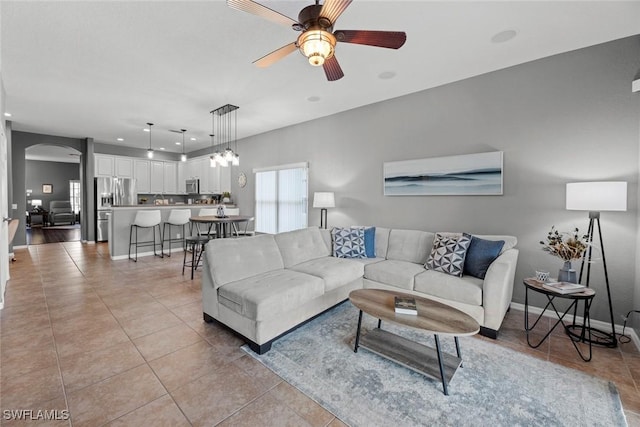 living room featuring light tile patterned flooring and ceiling fan