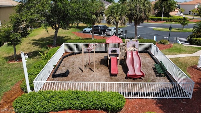 view of playground with a lawn