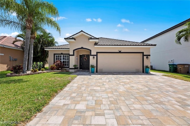 view of front of property featuring a garage and a front yard