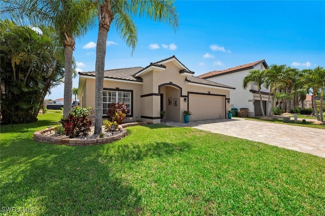 mediterranean / spanish home featuring a garage and a front yard